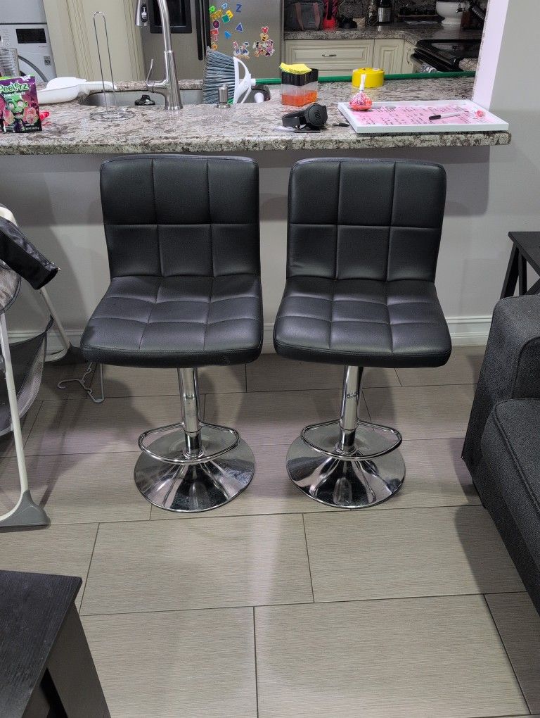 Two Black Adjustable Bar Stools