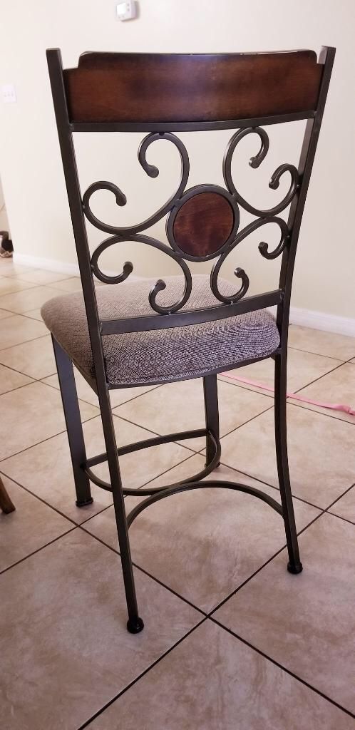 Brown dining table with built in wine rack and chairs