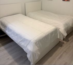 Two twins bed with mattress and two nightstands included.
