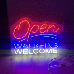 Neon sign “Open for business , walk ins welcome”