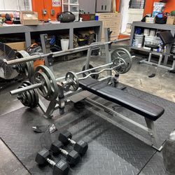 weight bench 500+ lbs, dumbbells, preacher curl machine, squat rack.