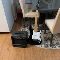silver tone electric guitar and amplifier 