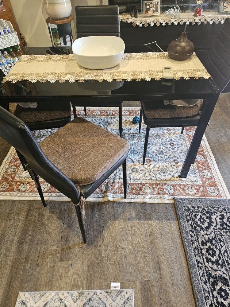 Black Glass Table With Four Chairs With Cushions