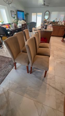 upholstered Parsons-style dining chairs with wood leg
