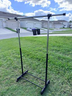 Selling an adjustable clothing rack with shoe storage, 50” x 64”.