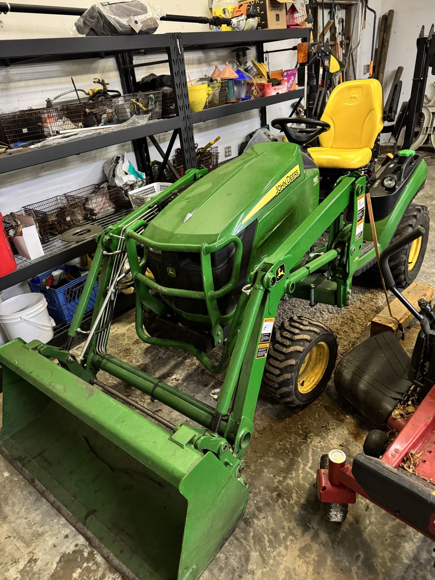 John Deere 1025R tractor with a bucket loader and backhoe