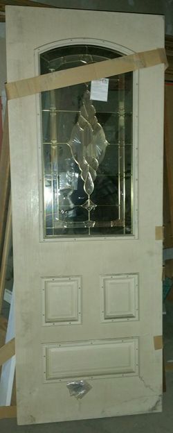 A BRAND NEW 8'FT. ENTRY DOOR W/CRYSTAL GLASS & METAL DESIGN INSERT