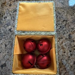This set consists of four red metal bells in a decorative Chinese brocade box.
