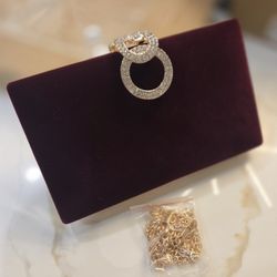 Maroon clutch purse with gold shoulder strap 