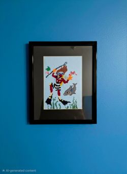 framed needlepoint art features a diver in a red suit holding a spear gun 9"×11"