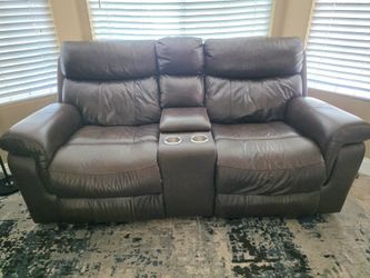 Brown leather couch and love seat.