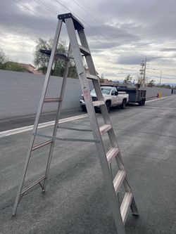 Sears/Craftsman 8-foot aluminum A-frame step ladder.