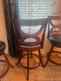 Brown wooden  swivel bar stools