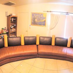 large curved leather couch seats 6, perfect for a theatre room!