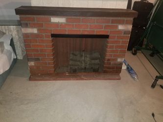 Decorative brick fireplace with fire logs that glow with fire and blows heat $400 obo
