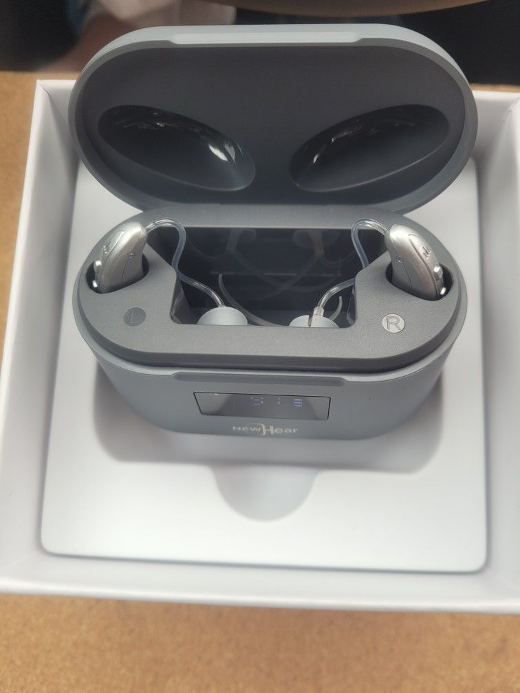 Ultra BTE OTC Hearing Aids in their charging case.