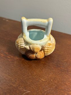 Vintage ceramic sand bucket figurine covered in little sea shells