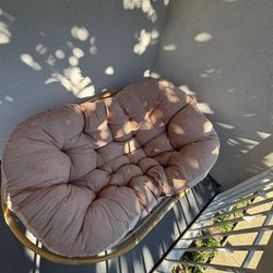papasan chair with a corduroy cushion and rattan frame