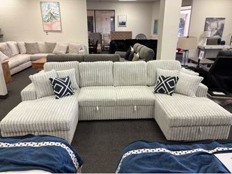 Sleeper sofa with storage and magazine rack in arms