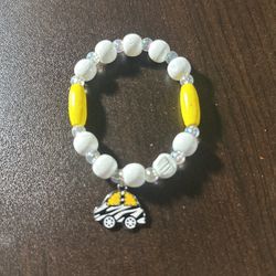 White, Yellow, And Clear Beads Bracelet With A Black White And Yellow Car Charm