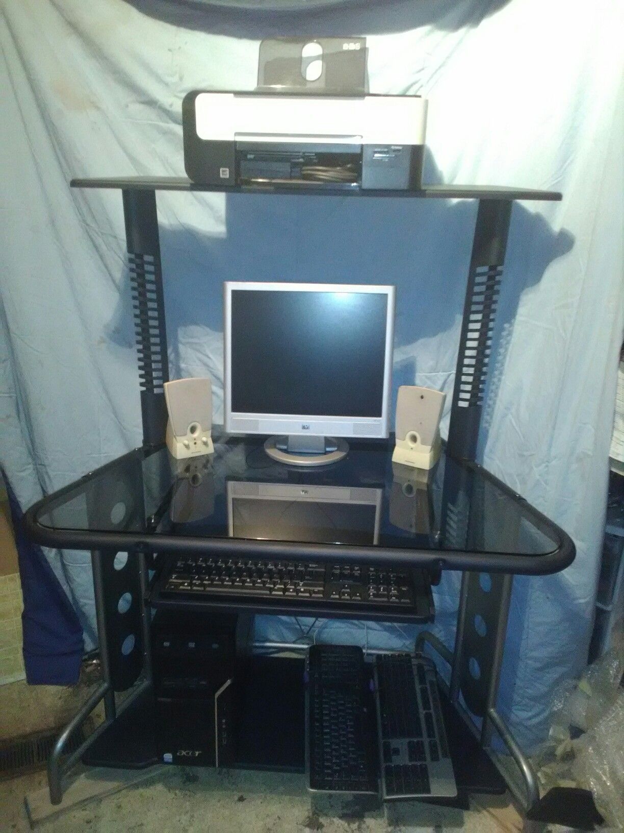 Glass computer desk,printer/copier,pc tower, monitor, PC speakers, 3 keyboards.