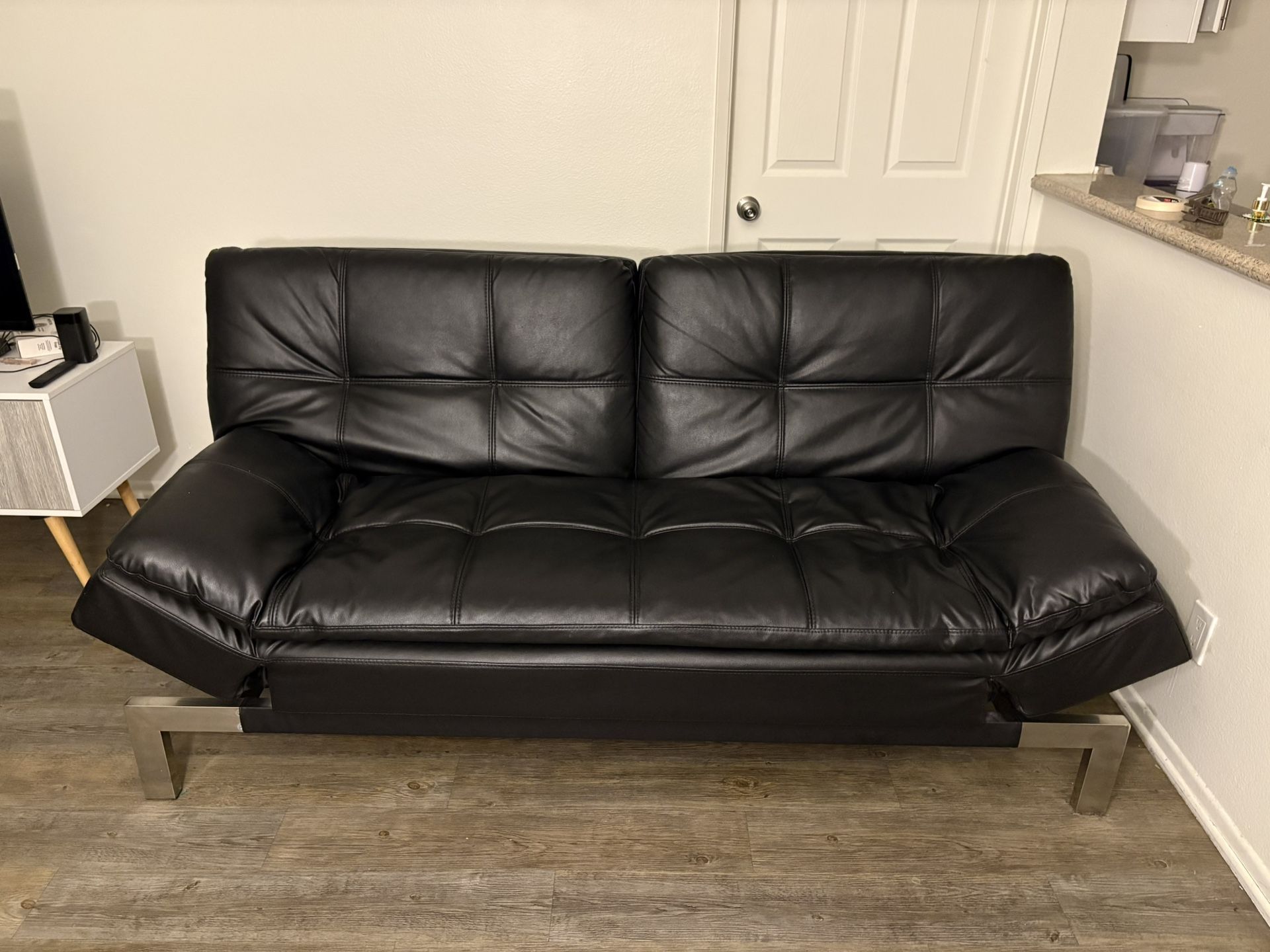 Multi-way adjustable black leather futon
