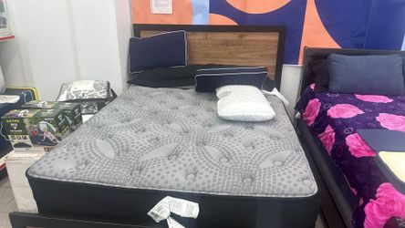 Ashely queen bed , foundation and mattress . on display. on sale