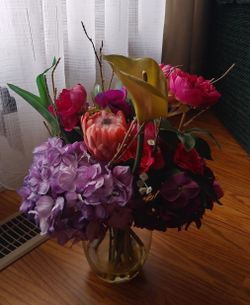 Beautiful fake decorative flowers in pot