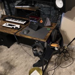 dark wood table with bad on the side headphone holder and mini table