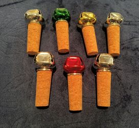 7 colorful bottle stoppers with bells on top. Appear unused