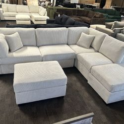 Cream Reversible Chaise Sectional And Ottoman 
