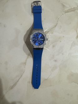 Ice Star branded watch featuring a silver-tone bezel covered in rhinestones and a vibrant blue silicone band.