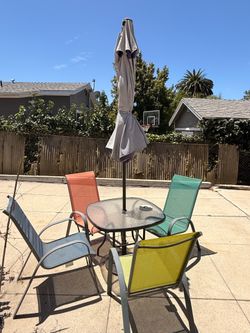 Colorful 6-piece patio set includes a square tempered glass-top table with a black metal frame.