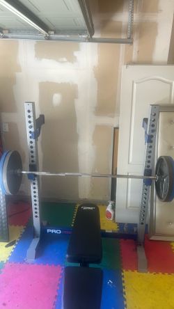 Olympic weights close to 300 pounds Olympic bar and also Olympic bench plus squat rack