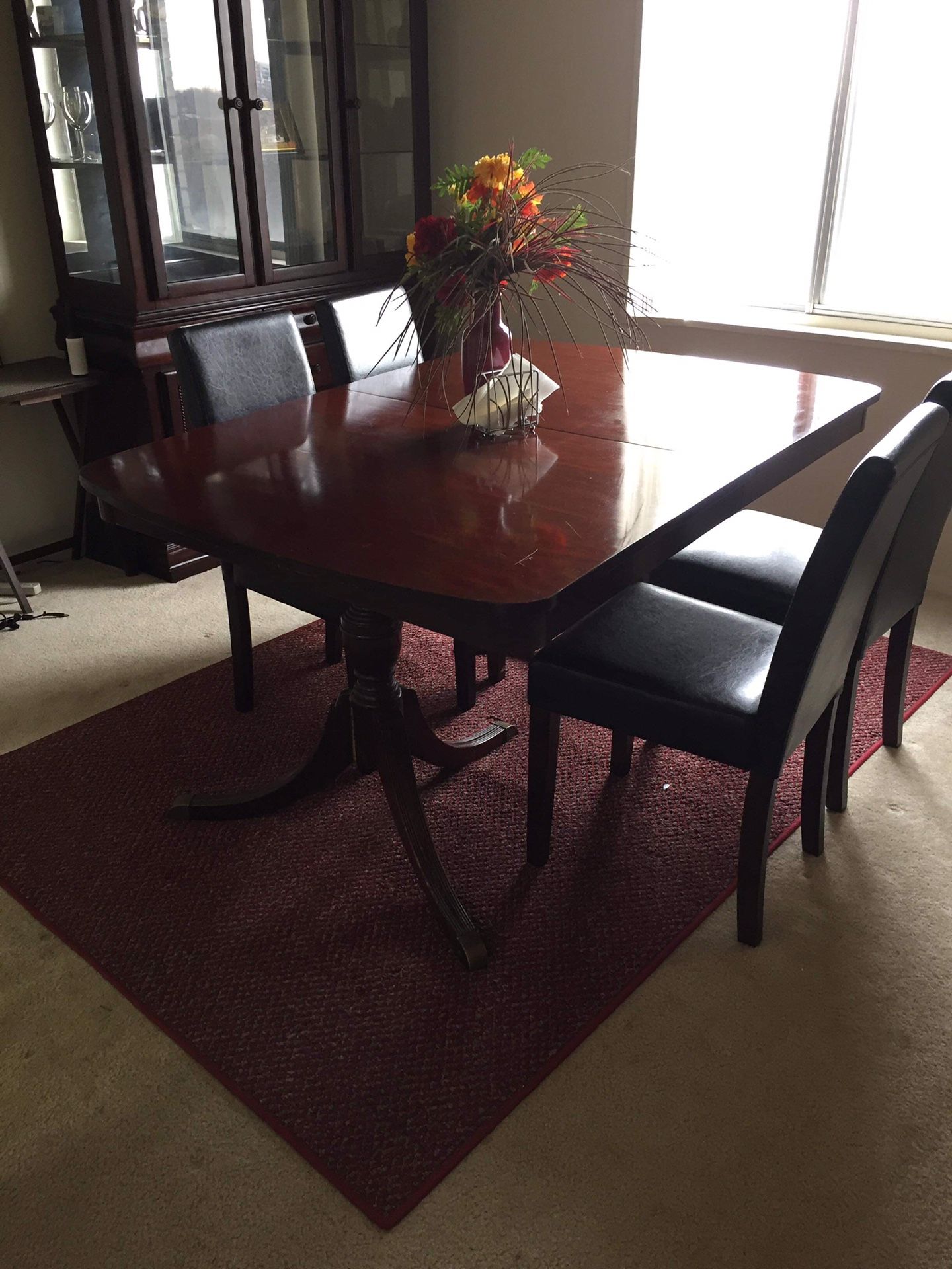 Couch and a dining table with perfectly maintained chairs