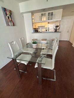 Glass dining table and 4 white chairs
