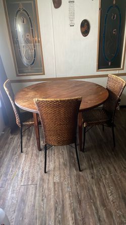 Heavy hardwood table with 3 wicker chairs