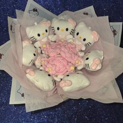 small Hello Kitty plush toys arranged like a bouquet of flowers with pink crochet "flowers" in the center. 