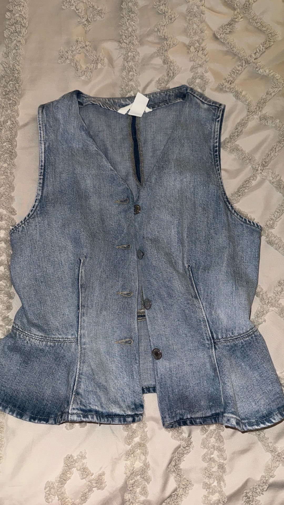 light-wash denim vest.