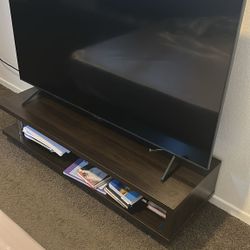 Samsung TV  and brown furniture. 