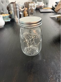 It is a glass jar with LED fairy lights inside.