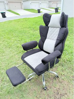 Reclining fabric office/gaming chair (upholstered) with retractable footrest.