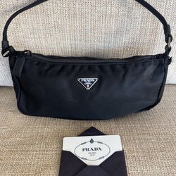 Prada Shoulder bag in canvas . It is a small bag in black 