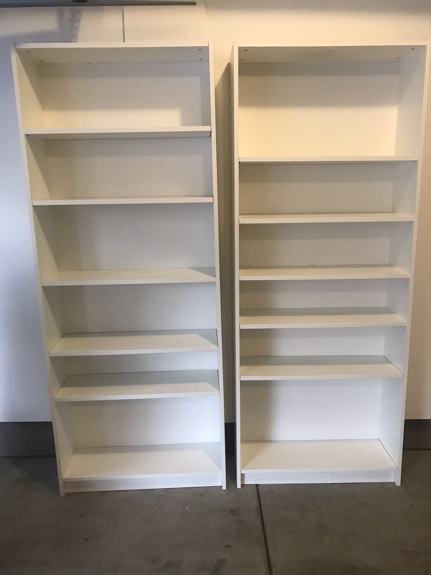 Two white IKEA bookshelves