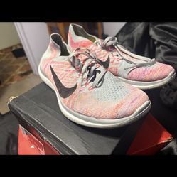 Gray And orange nike flyknit 