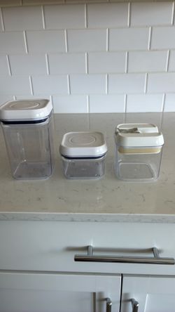 Three kitchen storage containers with lids