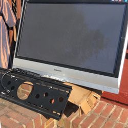 Panasonic wall mounted flat panel TV with remote cables and mounting hardware