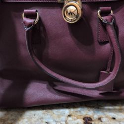 Michael Kors Hamilton large tote bag likely in a burgundy Saffiano leather with gold-tone lock