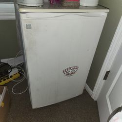 Small GE mini-fridge.  White.  Ron Jon Surf Shop sticker.  Used condition.  Good working order.