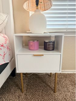 two white nightstands with good accents